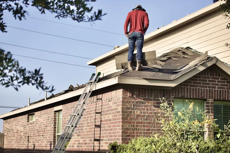 Professional roofer working on a residential roof in East Lake Worth